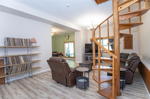 10201 County Road 5440, Rolla, MO 65401 - living area featuring wood finished floors, a chandelier, stairway, and ceiling fan