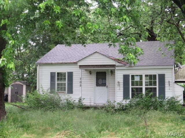 705 S Arch St, Jerseyville, IL 62052 - view of front of property with a shed and roof with shingles