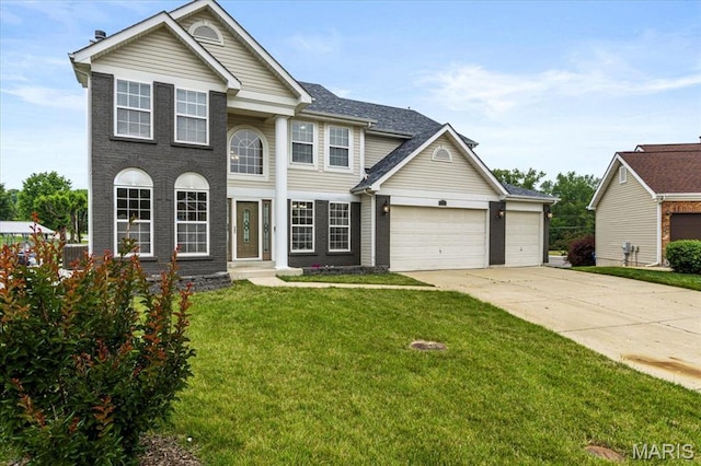4507 Behlmann Grove Pl, Florissant, MO 63034 - view of front facade with concrete driveway, an attached garage, and a front lawn