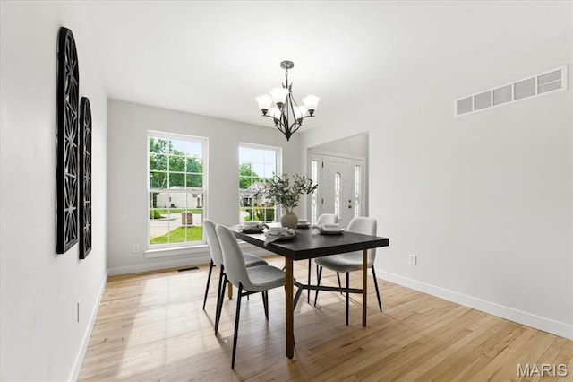 4507 Behlmann Grove Pl, Florissant, MO 63034 - dining room featuring a chandelier and light wood-style flooring