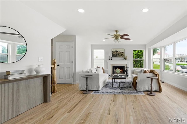 4507 Behlmann Grove Pl, Florissant, MO 63034 - living room featuring light wood-type flooring, a ceiling fan, a lit fireplace, and recessed lighting