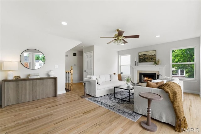 4507 Behlmann Grove Pl, Florissant, MO 63034 - living area featuring wood finished floors, healthy amount of natural light, a lit fireplace, a ceiling fan, and recessed lighting