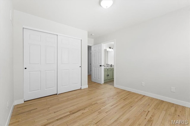 4507 Behlmann Grove Pl, Florissant, MO 63034 - unfurnished bedroom featuring light wood-style floors, a closet, and connected bathroom