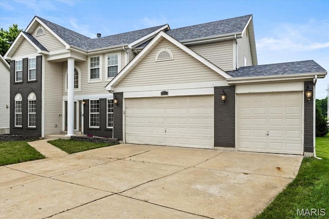 4507 Behlmann Grove Pl, Florissant, MO 63034 - view of front facade featuring concrete driveway, a garage, brick siding, and roof with shingles