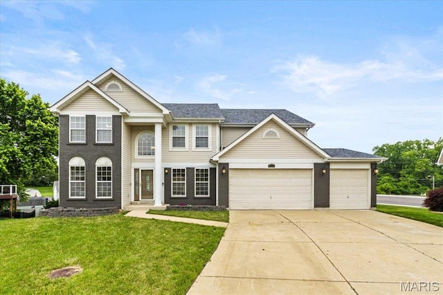 4507 Behlmann Grove Pl, Florissant, MO 63034 - view of front of home featuring concrete driveway, a front lawn, a garage, and a shingled roof