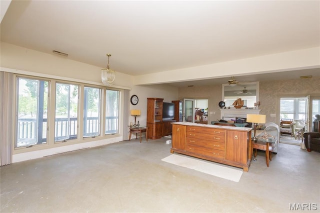 380 Yachtview Dr, West Alton, MO 63386 - kitchen featuring open floor plan, brown cabinetry, plenty of natural light, and a ceiling fan