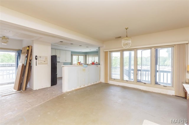 380 Yachtview Dr, West Alton, MO 63386 - unfurnished living room with plenty of natural light and a chandelier