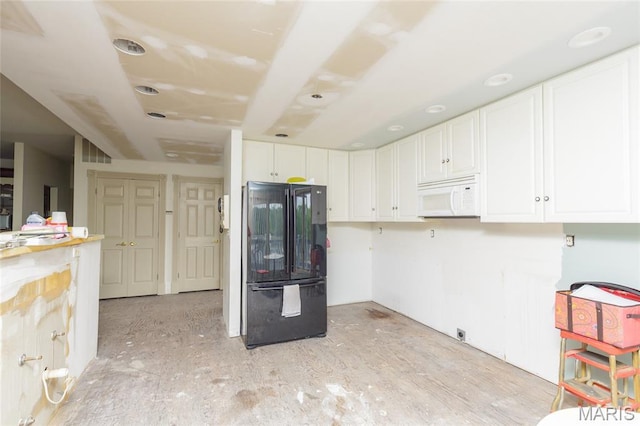 380 Yachtview Dr, West Alton, MO 63386 - kitchen featuring freestanding refrigerator, white microwave, and white cabinetry