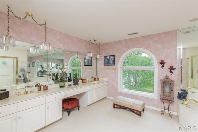 380 Yachtview Dr, West Alton, MO 63386 - bathroom featuring a chandelier, double vanity, and a shower with door