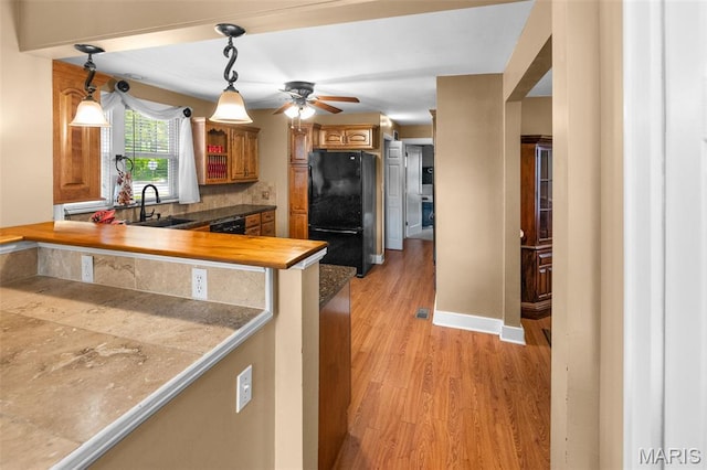 900 Danforth St, Alton, IL 62002 - kitchen featuring freestanding refrigerator, ceiling fan, light wood-type flooring, dishwashing machine, and brown cabinetry