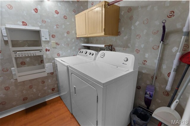 900 Danforth St, Alton, IL 62002 - washroom with wallpapered walls, separate washer and dryer, light wood finished floors, and cabinet space