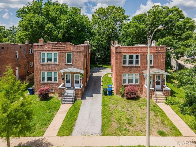 1323 Woodland Dr, Saint Louis, MO 63117 - townhome / multi-family property featuring brick siding and driveway