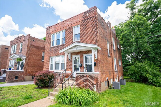 1323 Woodland Dr, Saint Louis, MO 63117 - view of front facade with brick siding and a front yard