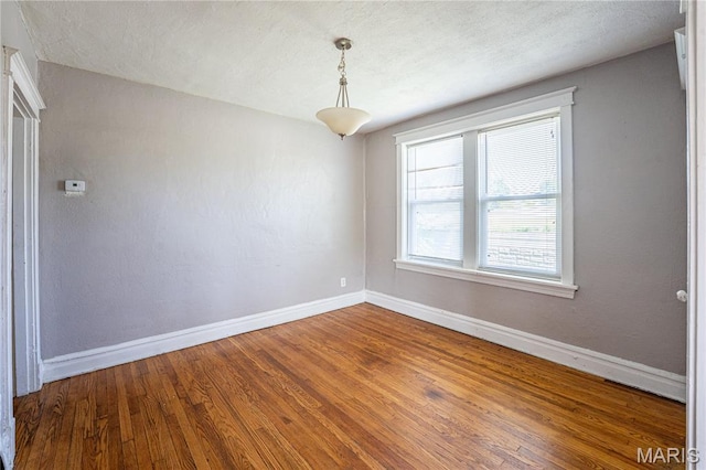 1323 Woodland Dr, Saint Louis, MO 63117 - empty room with baseboards and wood finished floors