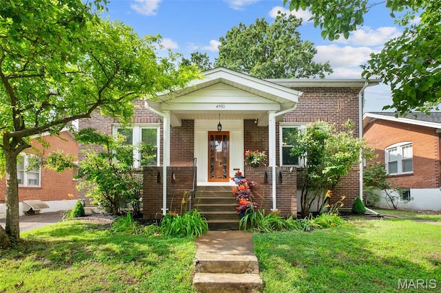4950 Eichelberger St, Saint Louis, MO 63109 - bungalow-style home with a front yard, brick siding, and covered porch