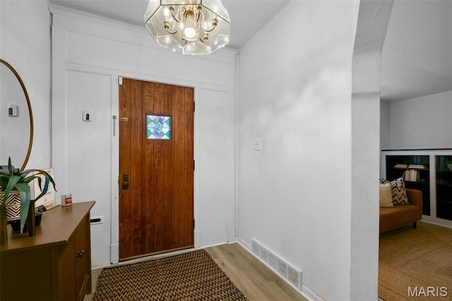 4950 Eichelberger St, Saint Louis, MO 63109 - foyer entrance featuring light wood-type flooring and a chandelier