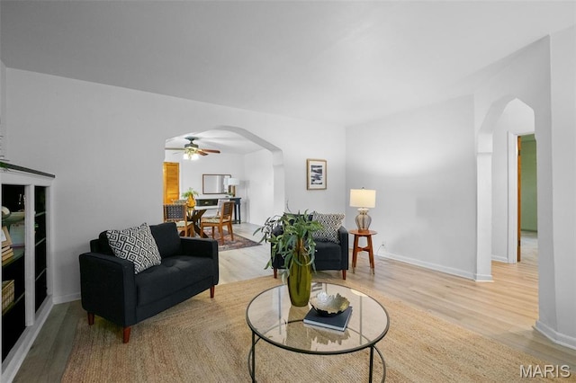 4950 Eichelberger St, Saint Louis, MO 63109 - living area with arched walkways, wood finished floors, and a ceiling fan