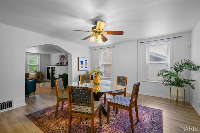 4950 Eichelberger St, Saint Louis, MO 63109 - dining space featuring arched walkways, hardwood / wood-style floors, and ceiling fan
