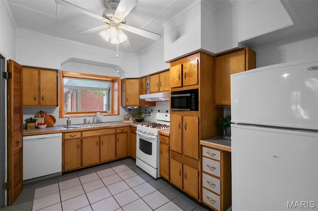 4950 Eichelberger St, Saint Louis, MO 63109 - kitchen with white appliances, under cabinet range hood, ceiling fan, light tile patterned floors, and brown cabinets