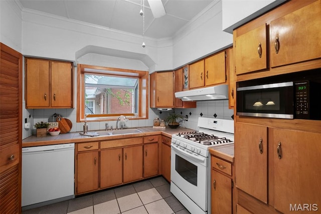 4950 Eichelberger St, Saint Louis, MO 63109 - kitchen with white appliances, under cabinet range hood, tasteful backsplash, tile countertops, and crown molding