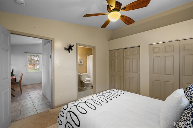 4950 Eichelberger St, Saint Louis, MO 63109 - bedroom with two closets, light tile patterned flooring, ensuite bathroom, light colored carpet, and ceiling fan