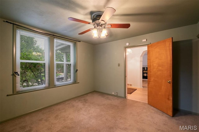 4950 Eichelberger St, Saint Louis, MO 63109 - unfurnished room featuring arched walkways, ceiling fan, and carpet floors
