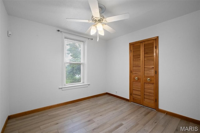 4950 Eichelberger St, Saint Louis, MO 63109 - unfurnished bedroom featuring light wood finished floors, a closet, and ceiling fan