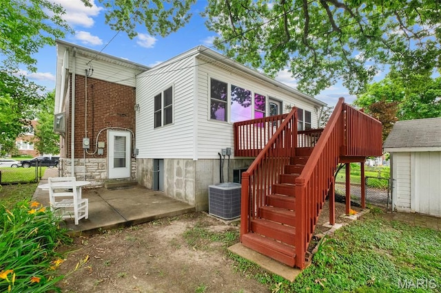 4950 Eichelberger St, Saint Louis, MO 63109 - back of property with a patio, stairway, a wooden deck, and brick siding