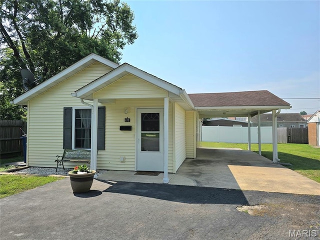 411 Williams St, Bethalto, IL 62010 - view of front of house featuring asphalt driveway, an attached carport, and roof with shingles