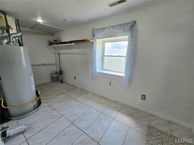 411 Williams St, Bethalto, IL 62010 - basement featuring water heater and tile patterned floors