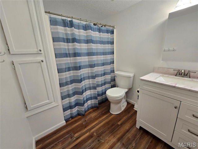 411 Williams St, Bethalto, IL 62010 - bathroom with vanity, wood finished floors, a textured ceiling, and a shower with shower curtain