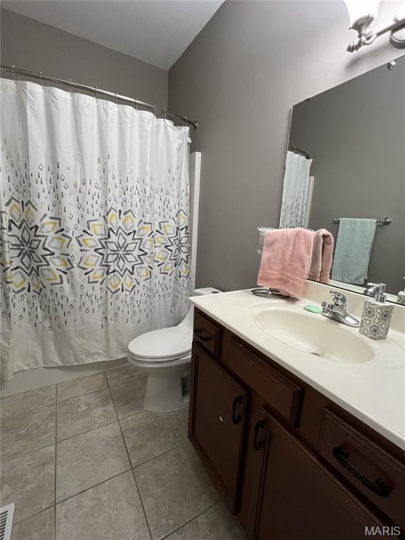 306 Traci Dawn Dr, Rolla, MO 65401 - bathroom with vanity, tile patterned floors, and a shower with shower curtain
