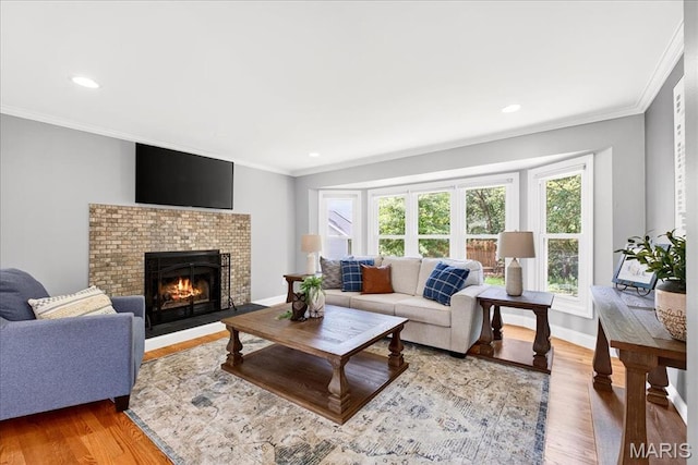 16544 Willow Glen Dr, Wildwood, MO 63040 - living area with plenty of natural light, light wood-style floors, a brick fireplace, crown molding, and recessed lighting