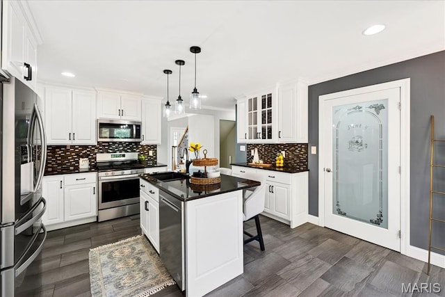 16544 Willow Glen Dr, Wildwood, MO 63040 - kitchen with appliances with stainless steel finishes, dark countertops, recessed lighting, and white cabinets