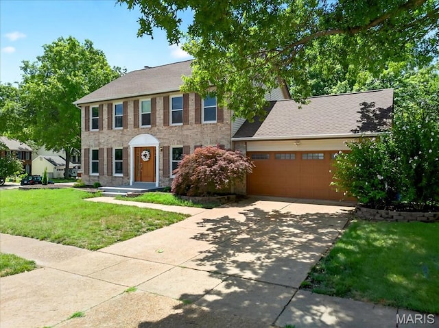 16544 Willow Glen Dr, Wildwood, MO 63040 - colonial home featuring a front lawn, driveway, an attached garage, and brick siding