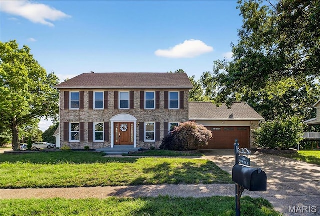 16544 Willow Glen Dr, Wildwood, MO 63040 - colonial house with driveway, a front yard, stone siding, and a garage