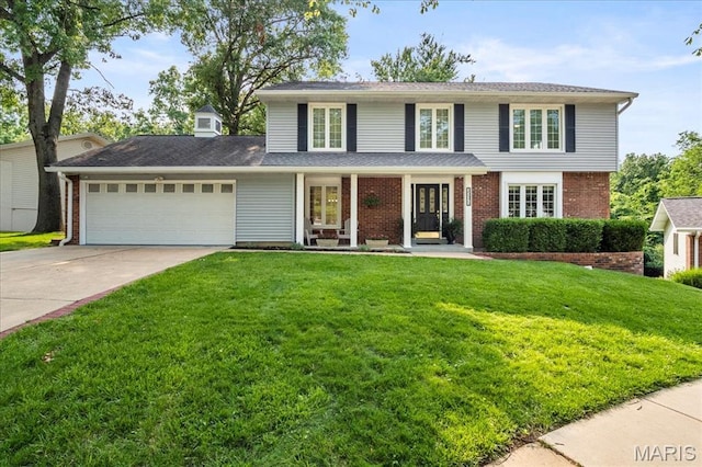 15371 Timber Hill Ln, Chesterfield, MO 63017 - view of front of property featuring an attached garage, a front lawn, driveway, brick siding, and a porch
