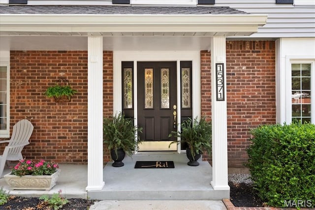 15371 Timber Hill Ln, Chesterfield, MO 63017 - doorway to property featuring a porch and brick siding