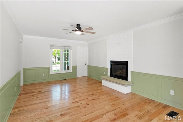 15371 Timber Hill Ln, Chesterfield, MO 63017 - unfurnished living room featuring a decorative wall, a ceiling fan, ornamental molding, wood finished floors, and a fireplace