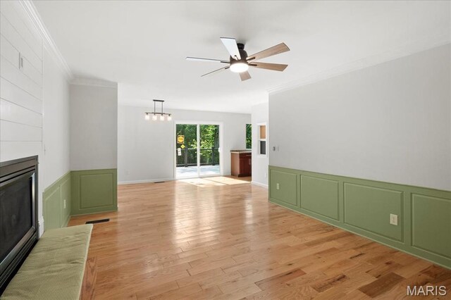 15371 Timber Hill Ln, Chesterfield, MO 63017 - unfurnished living room with a large fireplace, a decorative wall, ornamental molding, a ceiling fan, and light wood-type flooring