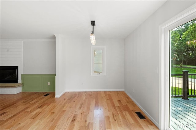 15371 Timber Hill Ln, Chesterfield, MO 63017 - unfurnished dining area with light wood-style floors and a large fireplace