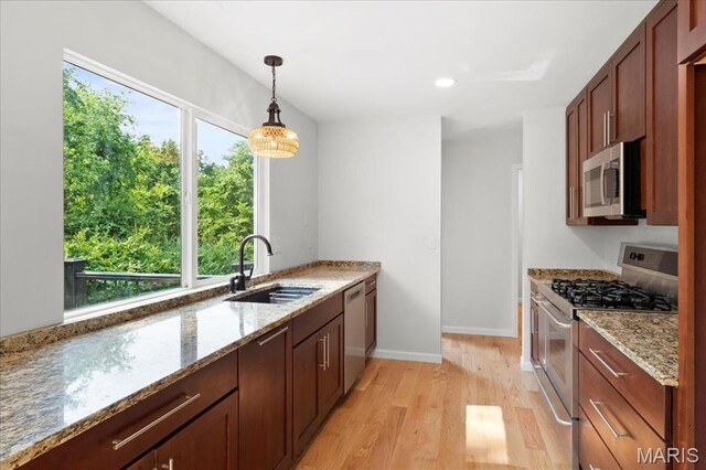15371 Timber Hill Ln, Chesterfield, MO 63017 - kitchen with stainless steel appliances, light wood-type flooring, decorative light fixtures, light stone countertops, and recessed lighting