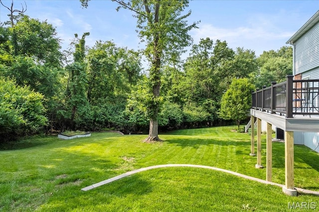 15371 Timber Hill Ln, Chesterfield, MO 63017 - view of grassy yard with a deck and view of wooded area