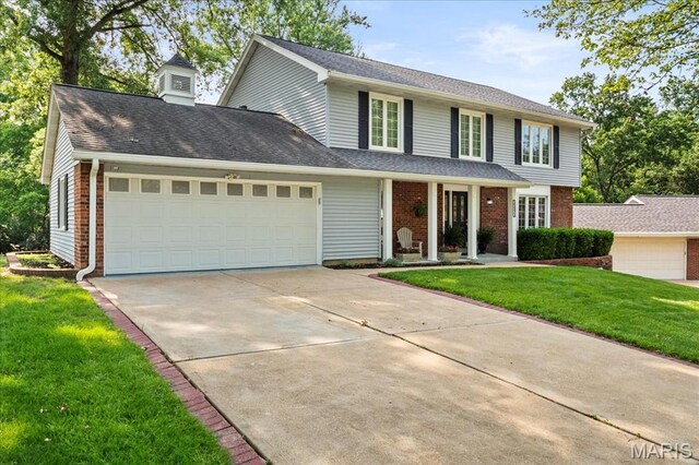 15371 Timber Hill Ln, Chesterfield, MO 63017 - view of front of property featuring brick siding, driveway, a garage, a front lawn, and a porch