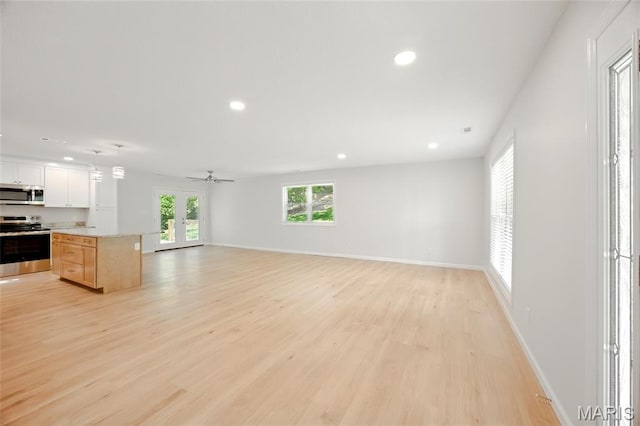 6905 Scenic View Dr, Cedar Hill, MO 63016 - unfurnished living room featuring french doors, light wood finished floors, recessed lighting, and a ceiling fan