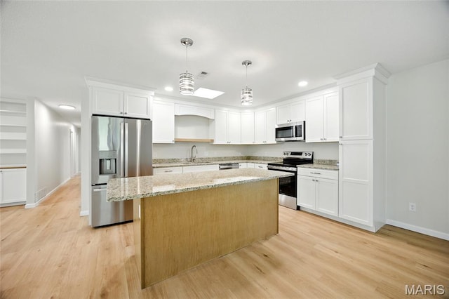 6905 Scenic View Dr, Cedar Hill, MO 63016 - kitchen featuring stainless steel appliances, a center island, light wood finished floors, recessed lighting, and white cabinetry