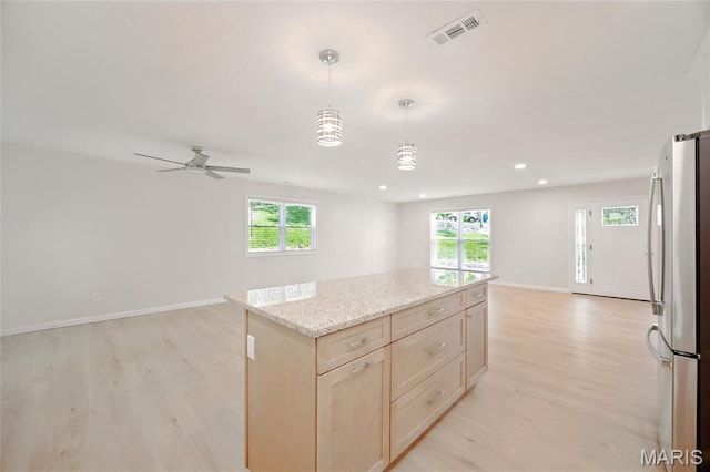 6905 Scenic View Dr, Cedar Hill, MO 63016 - kitchen with freestanding refrigerator, open floor plan, light wood-type flooring, light brown cabinets, and healthy amount of natural light