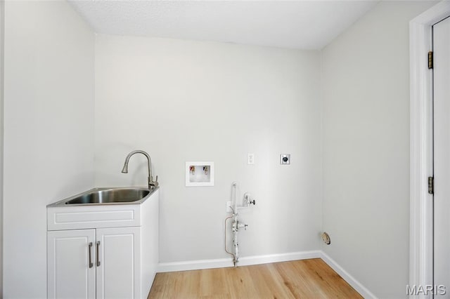 6905 Scenic View Dr, Cedar Hill, MO 63016 - laundry room featuring electric dryer hookup, hookup for a washing machine, light wood-style floors, and cabinet space