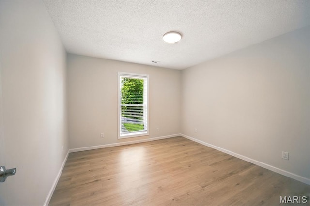 6905 Scenic View Dr, Cedar Hill, MO 63016 - empty room with light wood finished floors and a textured ceiling