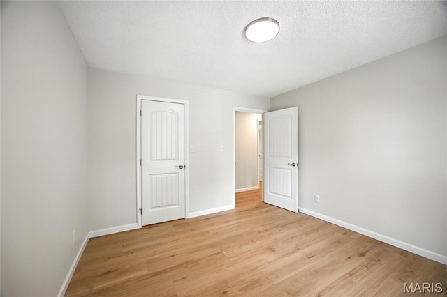 6905 Scenic View Dr, Cedar Hill, MO 63016 - unfurnished bedroom featuring light wood finished floors and a textured ceiling